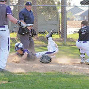 Boyceville's Walker Retz safely slides home versus Durand