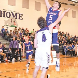 GLENWOOD CITY senior Hadin DeSmith glided high over Boyceville defender Brendan Sempf to score two of his game-high 21 points in Hilltoppers' 77-26 victory over the Bulldogs in Boyceville last Friday, January 4. —photo by Shawn DeWitt