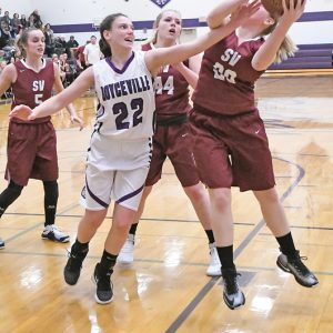 DEFENDING — Bulldog sophomore Jensine Boesl (#22) got a hand in the face of a Spring Valley shooter in a girls' conference basketball contest in Boyceville last Tuesday. The Bulldogs won 46-39. —photo by Shawn DeWitt