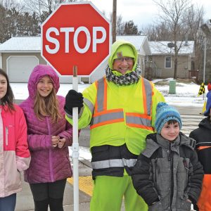 CROSSING GUARD WEEK — Students at Colfax Elementary made cards for Wendy Lausted, crossing guard, and four students presented them to her on January 17 in honor of Crossing Guard Week January 14 to January 18. Lausted has been a crossing guard for the Colfax school district for 21 years. From left: Olivia Steinbach, Alannah Smestuen, Wendy Lausted, Jack Whitwam and Braydyn Hiitola. —photo by LeAnn R. Ralph