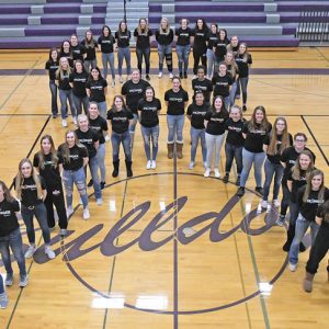 TEAMING UP TO FIGHT CANCER — Players on the Boyceville and Colfax girls' basketball teams stood in solidarity February 14 in the fight to end cancer. Together, players on both squads formed a ribbon in Boyceville's High School gym to kick off the 8th annual "Coaches versus Cancer" fundraiser before donning their respectively school colors to do battle on the hardwood. The event fetured a silent auction, raffles, and food with all proceeds going to the American Cancer Society to aid in its search for cures. —photo by Shawn DeWitt