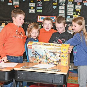 CLASSMATES OF JASE HOYT admired a special gift from Santa’s Helper. Hoyt, second from right, received this gift from a reader of the Tribune Press Reporter who lives in Oregon. Santa’s Helper was touched by the letter to Santa Claus written by Hoyt, who asked Santa to try to make his grandpa feel better, was published in the December 19th issue of this newspaper along with many other Christmas letters to Santa. Other members of Mrs. Bignell’s third grade class at Tiffany Elementary School looking over the Lego gift are from left: Arnold Sudbrink. Shea McGee, Vincent Schneider, Hoyt and Izyabella Becker. More photos can be found in this issue. —photo by Shawn DeWitt