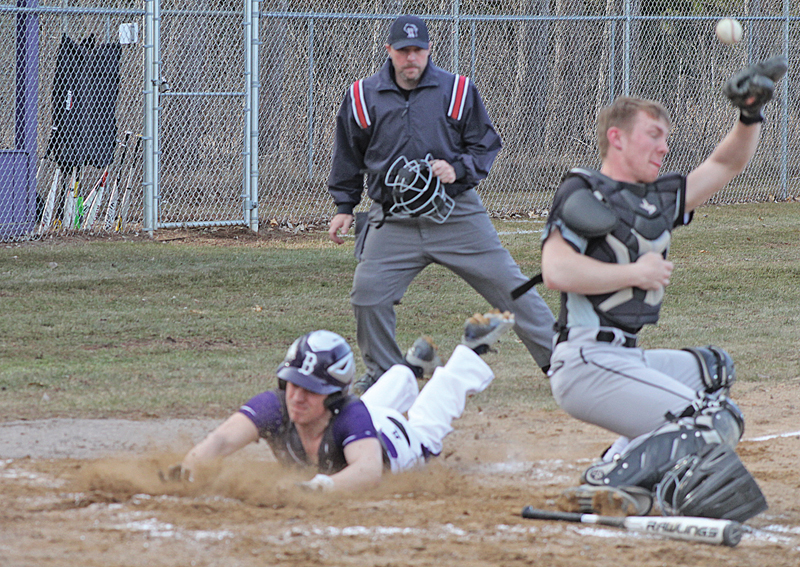 SAFE — Nick Litomsky (#7) slide safely home for a run in the second inning after beating the tag from the Elmwood/Plum City catcher. Boyceville sat at 3-0 in the D-SC after the 12-2 victory over the Wolves on April 16. —photo by Amber Hayden