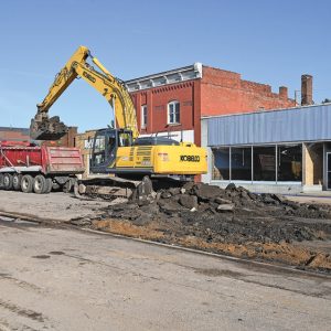 CONSTRUCTION IS UNDERWAY — The Main Street reconstruction project in the Village of Boyceville got underway this past Monday, April 15 with the removal of street lights and continued Tuesday morning as workers with the general contractor, The Skid Steer Guy of Eau Claire, begin to rip up and haul away the old asphalt pavement (pictured above). Temporary utilities, such as water service, were also being readied. The project is expected to continue through mid-August with a completion date just prior to the annual Cucumber Festival. —photo by Shawn DeWitt