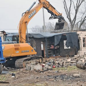 RAZING THE FORMER FRIEBURG FARM EQUIPMENT BUILDING was done on Monday, April 29 to make room for a new fitness center in Boyceville. The building once was used by Hedlund Manufacturing for their farm equipment, and is located at the intersection of Main and East Streets. —photo by Carlton DeWitt