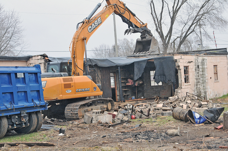 RAZING THE FORMER FRIEBURG FARM EQUIPMENT BUILDING was done on Monday, April 29 to make room for a new fitness center in Boyceville. The building once was used by Hedlund Manufacturing for their farm equipment, and is located at the intersection of Main and East Streets. —photo by Carlton DeWitt