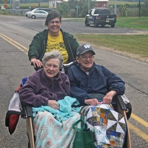 CHRC photo - Joy and Sid enjoying a ride on our new bike being driven by Melissa.