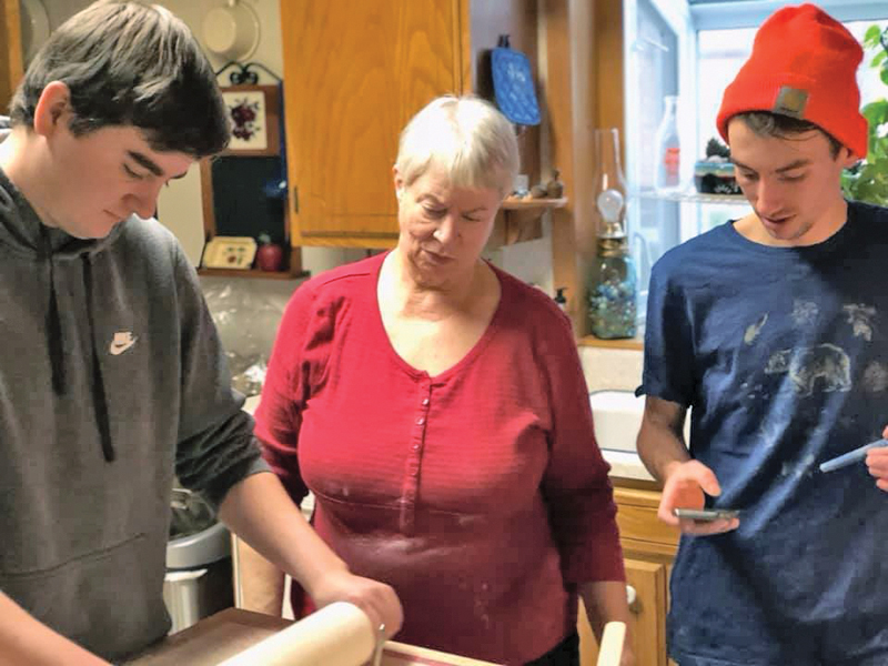 Paula DeWitt with grandsons Ross and Tyler making lefse