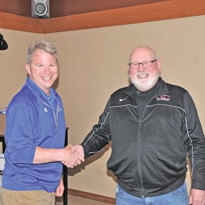 Mayor John Larson, right welcomes Randall Ketola to his seat at the City Council table