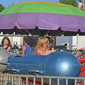 BOMBER RUNS — The airplane ride at the Dunn County Fair appeared to be a popular choice for the kiddos. —photo by LeAnn R. Ralph