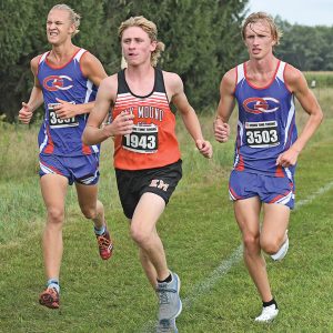 THE TOPPERS’ JJ Williams (left) and Austin Nelson ran along side each other and and Elk Mound competitor during the cross country season opener at the Boyceville Invitational. Williams placed third with a time of 17:42.3 while Nelson came in eighth after clocking the 5,000 meter course in 18:05.6. The Glenwood City boys placed third behind Prescott and Elk Mound. —photo by Shawn DeWitt