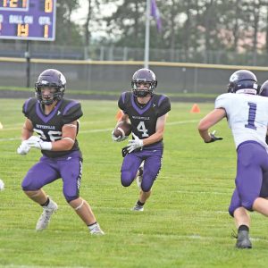 RUNNING TOWARD an opening created by his linemen, Boyceville’s Nick Olson (#4) gain positive yards on this play during the Bulldogs’ home and season football opener against Independence/Gilmanton last Friday, August 20. Olson eventually scored the game’s first touchdown, a 9-yard jaunt, on this drive to give Boyceville an early 6-0 lead after one quarter of action. The Bulldogs went on to thump the Indees by a count of 47-6. —photo by Shawn DeWitt