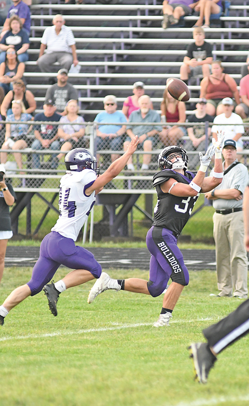 EYE ON THE BALL — Bulldog running back Tyler Dormanen (#33) got behind an Indee defender and tried to haul in this long pass from quarterack Ira Bialzik during the first half of Boyceville’s home and season opener against Independence/Gilmanton August 20. Unfortunately, Dormanen was unable to complete the catch. —photo by Shawn DeWitt