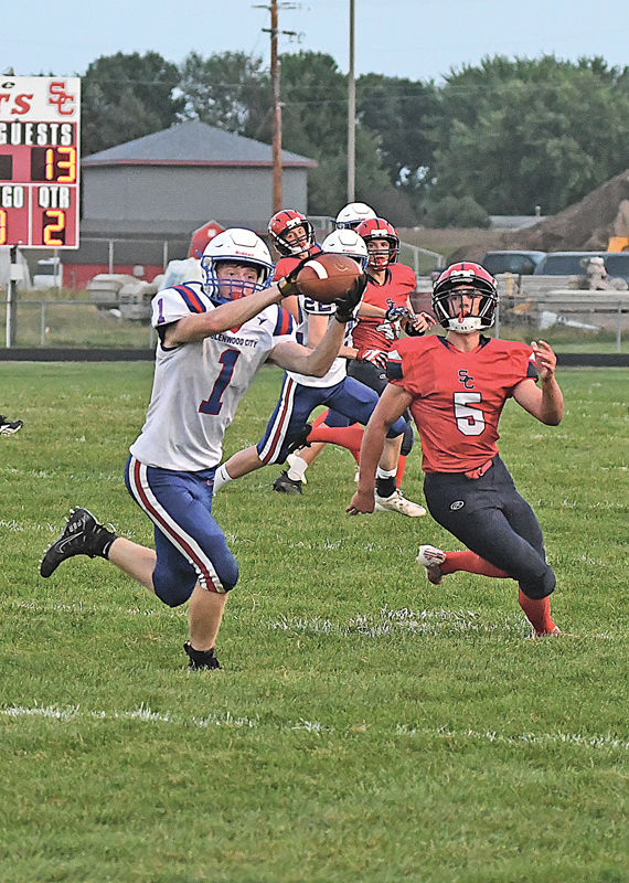 INTERCEPTION — Glenwood City senior Brady McCarthy (#1) stepped in front of Spencer/Columbus Catholic’s Brock Bennington (#5) to intercept this pass during the second quarter of Glenwood City’s 2021 season opening football contest in Spencer last Thursday, August 19. After taking a quick 7-0 lead, turnovers hurt the Hilltoppers who lost 51-28. —photo by Shawn DeWitt
