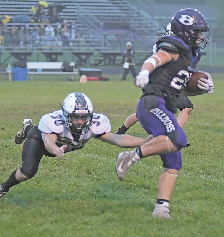 STEPPING OUT of this tackle attempt by Cadott’s Caleb Sonnetag, Boyceville junior running back Bash Nielson ran for a 76-yard touchdown on the Bulldogs’ first play from scrimmage in last Friday’s conference football opener at Evenson Field. Nielson finished with 188 yards rushing and two touchdowns in the Bulldogs’ 50-22 win over Cadott. —photo by Shawn DeWitt