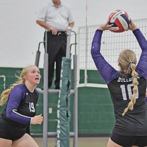 COMPETING IN a quad meet in Fall Creek last week, Harper Olson (#10) set the volleyball for her middle hitter, Libby Bygd (#19). —photo by Rochell Olson