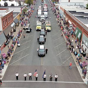9-11 TRIBUTE — Silence descended for a few minutes at the start of this year’s Rustic Lore Parade on Sunday afternoon, September 12 as area fire, EMS and law enforcement agencies, joined by the many parade spectators, stood and honored those that lost their lives in the September 11, 2001 terrorists attacks on the United States. Fire fighters, EMS personnel and law officers saluted as the national anthem was sung by Glenwood City senior Bella Simmons in a tribute commemorating the 20th anniversary of the attack. Agencies participating in the tribute included fire departments from Glenwood City, Boyceville, United Fire (Baldwin, Woodville, Hammond and Roberts), Sand Creek, Elk Mound; ambulances from Glenwood City, Boyceville and Clear Lake; the Glenwood City Police Department and St. Croix County Sheriff’s Office. —aerial drone photo by Reyse Klatt
