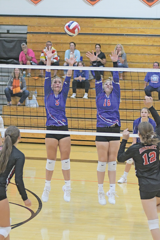 GLENWOOD CITY’S Amalia Draxler (left) and Arianna DeSmith attempted to block this shot during a volleyball match in Elk Mound. —photo by Shawn DeWitt