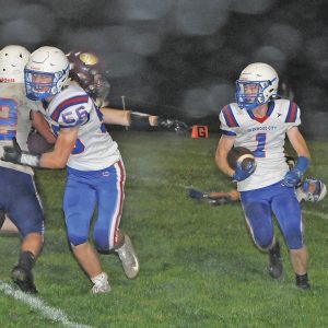 LONG RUN — With blocker Thomas Moede (#52) leading the way, Brady McCarthy (#1) ran for a 52-yard touchdown late in the second quarter as the Toppers went ahead of host Turtle Lake 24-6 in last Friday’s football game. Glenwood City held on to pick-up its second straight road victory with a 24-12 final. —photo by Joel DeWitt