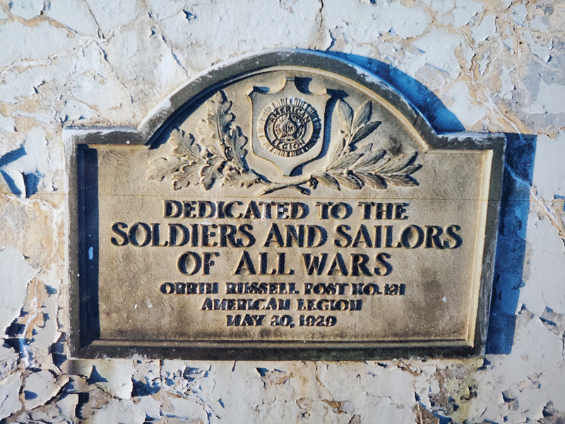 STILL A MYSTERY — This bronze plaque given by the Orrin Russell Post No. 131 American Legion in 1929 used to be displayed on the base of the flagpole that was formerly located in the triangle at the intersection of state Highway 40 and University Avenue/Main Street in Colfax. The flagpole was moved in 2004 when state Highway 40 was reconstructed. The plaque was removed for cleaning — and has not been seen since. One of Colfax’s historians, Troy Knutson, took this picture of the plaque before the flagpole was moved. —photo courtesy of Troy Knutson