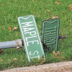 STREET SIGNS left laying in resident’s yards following the street construction of Highway 170 in Glenwood City. —photo by Carlton DeWitt