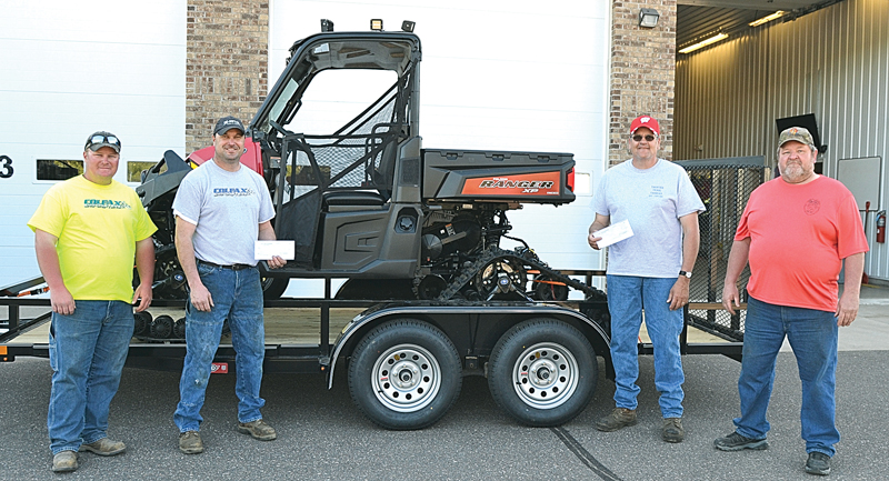SIDE-BY-SIDE — Don Logslett, who will be retiring as fire chief in January, accepted checks from members of the Colfax Sno-drifters and the Tainter Trail Tamers May 15, 2019, to help pay for the Polaris Ranger Utility Terrain Vehicle purchased by the fire department. From left Nate Erickson and Mike Buchner, Colfax Sno-Drifters; Scott Nussberger, Tainter Trail Tamers; and Don Logslett, Colfax fire chief. — Photo by LeAnn R. Ralph