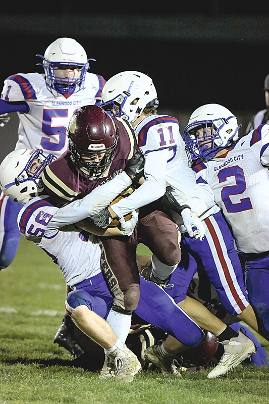 TEAM WORK — Thomas Moede (left ) and Brady Klatt collaborated to bring down a Turtle Laker runner for a loss during last Friday’s playoff win in Turtle Lake. —photo by Jacob Maes Photography