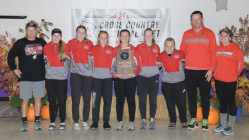 STATE BOUND — The Colfax girls’ cross country team captured the WIAA Division 3 sectional championship in Boyceville this past Saturday, October 23. The Lady Vikings scored 87 points to edge out Cameron for the team title and earn their first state berth since 2015. Coaches and runners from Colfax’s sectional championship squad are pictured above with the plaque. From left to right are: Head coach Joe Doucette, Molly Heidorn, Aynsley Olson, Kaysen Goodell, Jamine Best, Jaycey Bowe, Jenna Goodell, assistant coach Chuck Brown and assistant coach Kathleen Thorn. The Vikings will compete in the State Championships this Saturday, October 30 in Wisconsin Rapids. —photo by Jacob Maes Photography