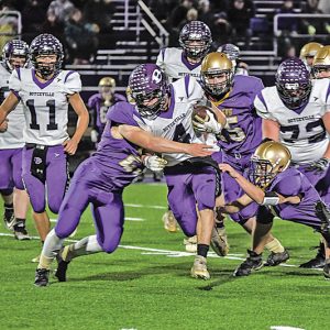 TOUGH YARDS — Sophmore back Nick Olson tried to pick up some yardage on this run with a Panther defender trying to take him to the turf during the October 29 playoff game in Durand. —photo by Rochelle Olson