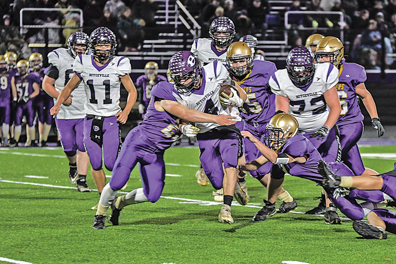 TOUGH YARDS — Sophmore back Nick Olson tried to pick up some yardage on this run with a Panther defender trying to take him to the turf during the October 29 playoff game in Durand. —photo by Rochelle Olson