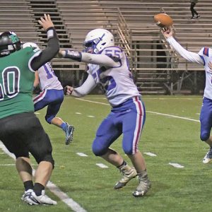 THE TOPPERS’ Collin LaValley makeing a block during the Division 7, level 2 football playoff game against Eau Claire Regis October 29 at Carson Park. —photo by Jacob Maes Photography