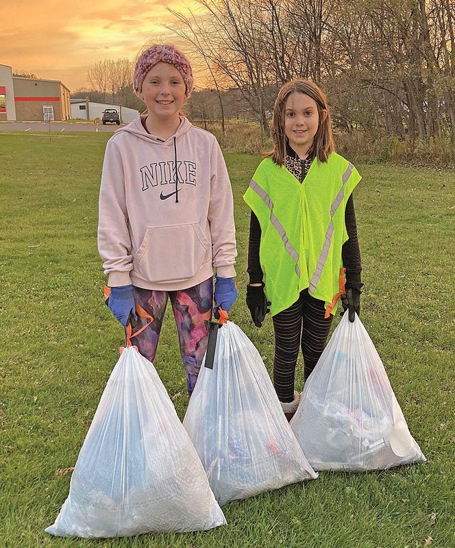 LOCAL Glenwood City Elementary 5th graders Abby Mewis (left) and Izzy Grutt spent time Friday evening and Saturday morning, November 5 and 6 picking up trash in town. The pair filled six and a half bags. —photo submitted