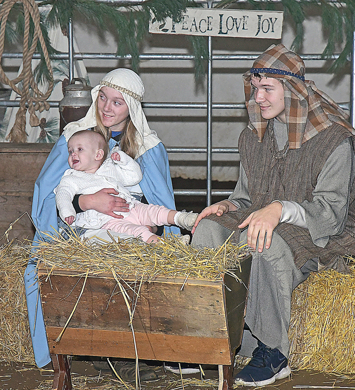 LIVE NATIVITY — “Christmas in the Barn” was presented by Holy Cross Lutheran Church Saturday and Sunday, December 4 and 5 on the rural Glenwood City farm of Dean and Jennifer Teigen. Above, Elsja Meijer, Will Standaert and toddler Audrey Stack, portraying Mary, Joseph and Baby Jesus, were part of Sunday’s performance. —photo by Shawn DeWitt
