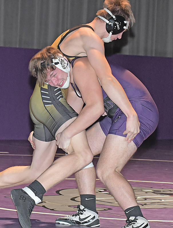 THE LIFT — Boyceville 195-pounder Sebastian “Bash” Nielson (right) began to lift his Cadott opponent, Wyatt Engel, off the mat for an eventual takedown during the Bulldogs’ home opener versus Cadott last Thursday, December 9. Nielson registered the pin at 3:59, just one of three victories Boyceville had in the 57-18 loss to state-ranked Cadott. —photo by Shawn DeWitt