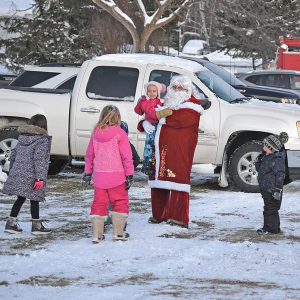LOOK! IT’S SANTA! — Santa Claus emerged from a fire truck at the Colfax Fairgrounds December 11 during the Colfantastic Light Up Colfax event. As soon as he was spotted by children, they came streaming over to greet him. —photo by LeAnn R. Ralph