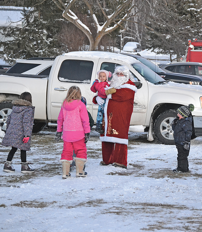LOOK! IT’S SANTA! — Santa Claus emerged from a fire truck at the Colfax Fairgrounds December 11 during the Colfantastic Light Up Colfax event. As soon as he was spotted by children, they came streaming over to greet him. —photo by LeAnn R. Ralph 