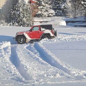 WISCONSIN WINTER SCENE—Tire tracks in the snow at the Tribune parking lot on Misty Court indicates that more than a foot of snow fell Friday night. Most activities were cancelled that evening. —photo by Carlton DeWitt