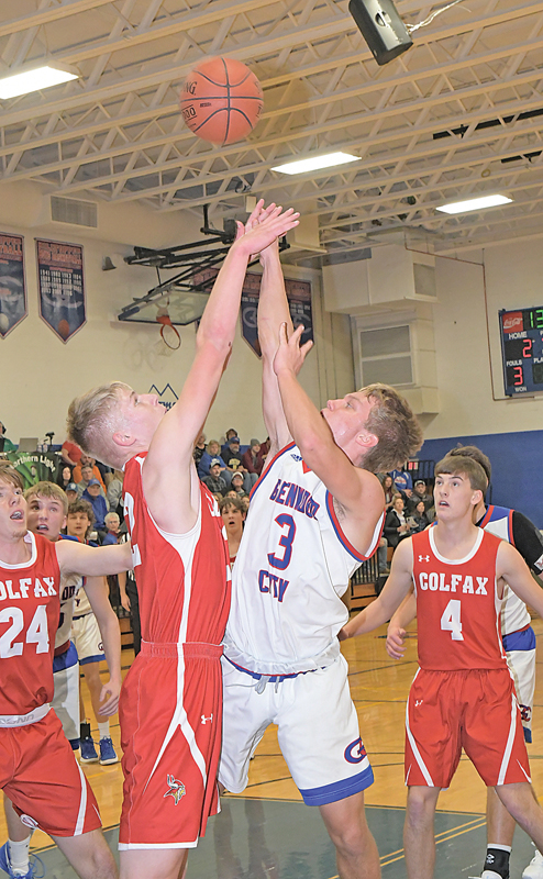 TOUGH SHOT — Topper Max Janson (#3) got this shot attempt over the outstretched arms of Colfax defender Tristan Lenz during a home basketball game December 7. Janson finished with six points in the 28-point loss to the Vikings. —photo by Shawn DeWitt