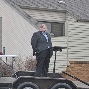 Vicar Charles Shingledecker at Outdoor Christmas Eve Worship at Kyle's Market