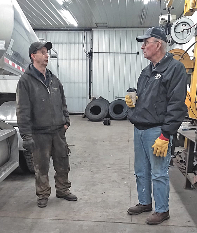 In the back shop at Elmwood are Sheldon Simonson, left and Pat Delander remising. —photo submitted