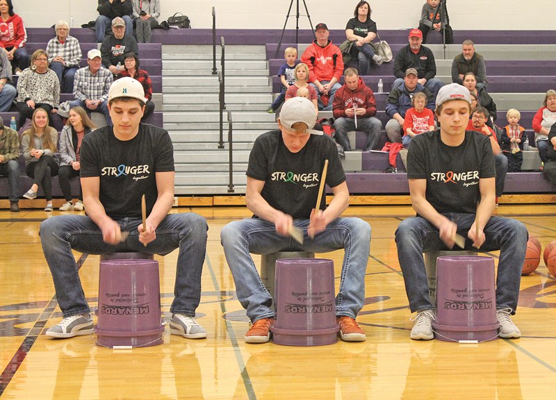 THREE BUCKETEERS— Connor Sempf, Jaden Reisimer and Brendan Sempf took to the court for a little pregame entertainment as they played the drums during the Coaches vs. Cancer event last Thursday evening, February 14. —photo by Amber Hayden