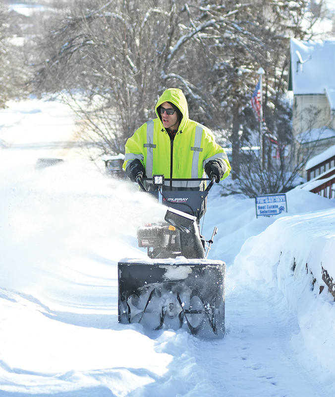 GLENWOOD CITY resident Davon Lindau using a snow blower